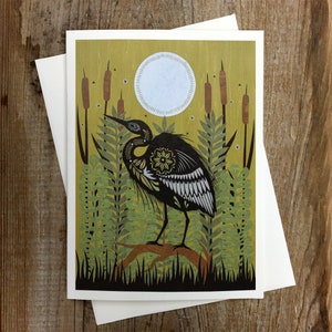 May include: A black and white illustration of a heron standing on a branch in a swamp. The heron has a detailed pattern on its feathers. The background is a yellow-green color with a white moon.