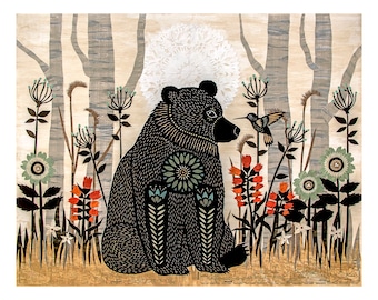 May include: A black bear with intricate patterns sits in a forest setting. The bear is surrounded by colorful flowers and a small hummingbird hovers nearby.