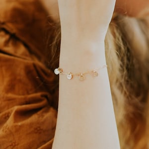 gold paperclip charm bracelet on model