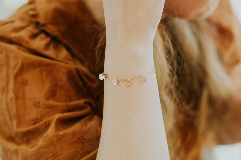 gold paperclip charm bracelet on model