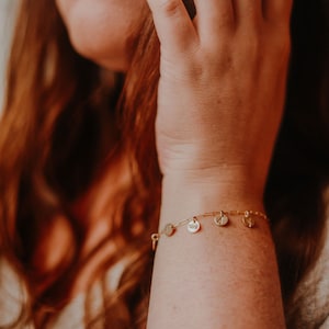 gold paperclip charm bracelet on model