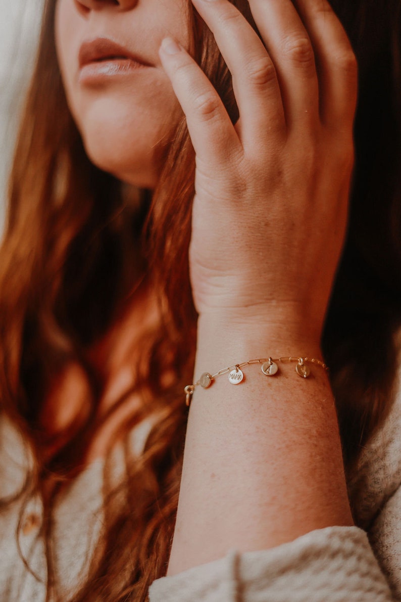gold paperclip charm bracelet on model
