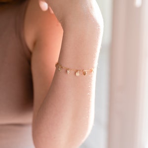 gold paperclip charm bracelet on model