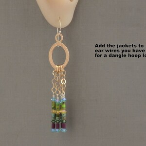 May include: Gold hoop earrings with a dangling chain of beads in shades of green, blue, and purple. "Add the jackets to ear wires you have for a dangle hoop look" is written in the image.