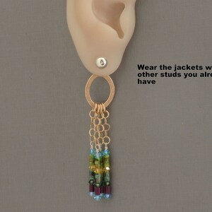 May include: Gold dangle earrings with a circle charm and a chain with multi-colored beads. "Wear the jackets with other studs you already have" text is visible in the image.