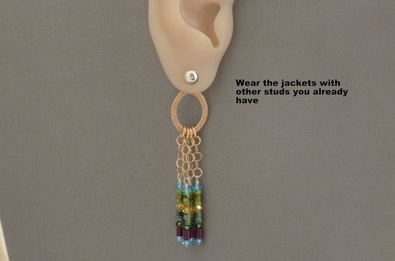 May include: Gold dangle earrings with a circle charm and a chain with multi-colored beads. "Wear the jackets with other studs you already have" text is visible in the image.