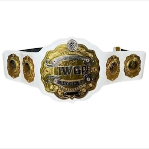 May include: A white wrestling championship belt with gold and silver accents. The center plate features the text "IWGP Intercontinental Champion" in gold lettering. The belt has several smaller gold plates on each side and a black strap.