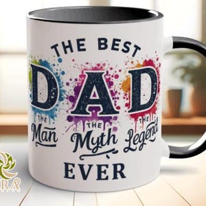 May include: White ceramic mug with a black handle and rim. The mug features the text "THE BEST DAD" in a bold font, with colorful paint splatter accents. Below the text are the words "The Man, The Myth, The Legend, EVER."