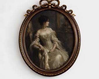 May include: An oval framed portrait of a woman in a white dress, seated and looking to the side. The frame is dark brown with a gold accent and a decorative bow at the top. The text "Madame Art Prints" is at the bottom.