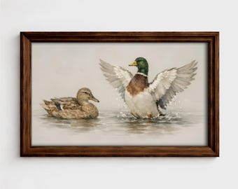 May include: Watercolor painting of two ducks in a lake, framed in a dark brown wooden frame. One duck is in the water with its wings spread, and the other is swimming nearby. The painting has a vintage aesthetic.
