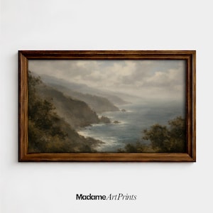 May include: A framed landscape print depicts a coastal scene with mountains, ocean, and cloudy skies. The artwork features a dark brown wooden frame. The text "Madame Art Prints" is at the bottom.