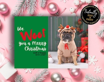 May include: A Christmas card with a dog wearing a reindeer costume. The card has a green panel with the text "We Woof you a Merry Christmas and a happy new year!". The background is pink with Christmas decorations.