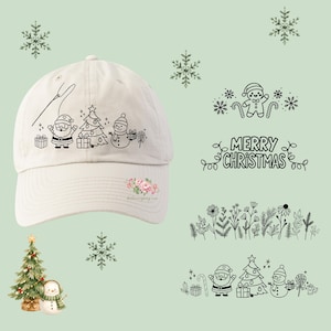 May include: A cream-colored baseball cap featuring a black line art illustration of Santa Claus, a Christmas tree, a snowman, and gifts. The design includes a needle and thread motif. Additional black line art graphics of holiday icons and flowers are displayed separately.