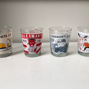 May include: Four vintage clear glass tumblers with humorous illustrations. Each glass features a different theme: "Golfer's Nite Cap," "Salesman's Nite Cap," "Fisherman's Nite Cap," and "Hunter's Nite Cap." The glasses have colorful graphics and text.