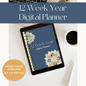 May include: A digital planner on a tablet with a blue cover and gold spiral binding. The cover features a mandala design in shades of blue, orange, and gold. The text "12 Week Year Digital Planner" is printed on the cover.