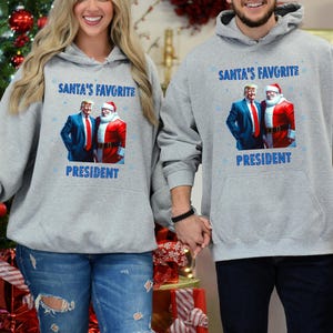 サンタのお気に入りのMYBteeShopシャツ、トランプクリスマススウェットシャツ、サンタトランプシャツ、クリスマス共和党セーター、面白いトランプ