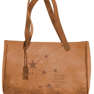May include: A brown leather tote bag with a constellation design and the text 'Be sure you are an Aquariuis' and the Aquarius zodiac symbol.