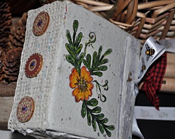 Chunky mini-4"x4" handmade blank journal filled with all studio handmade papers. Book is a recycled bar soap box. Hand painted marigold.