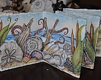 Handmade Accordian Style Art painting that closes into a 4 x 4 inch book, Ocean, sand sea shells, sanddollar, sand castle, hermit crab