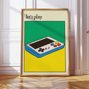 May include: A retro-style handheld video game console with a white body, blue trim, and colorful buttons. The console is on a yellow background with the text "Let's play." in black.