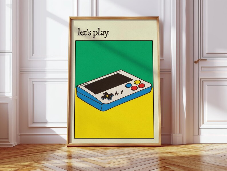 May include: A retro-style handheld video game console with a white body, blue trim, and colorful buttons. The console is on a yellow background with the text "Let's play." in black.