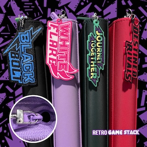 May include: Four colorful pencil cases with matching zipper pulls and keychains. The cases are black, purple, green, and red. Each keychain has a different design and text: "BLACK BOLT", "WHITE FLARE", "JOURNEY TOGETHER", and "DESTINED RIVALS". The text "RETRO GAME STACK" is at the bottom.