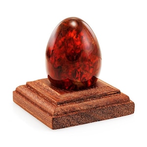 Easter egg made of molded amber in a red cognac shade on a wooden stand| Baltic Amber Collectible Gift| Home decor | Religious gift