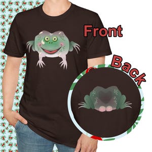 May include: A dark brown t-shirt featuring a cartoon frog design on the front and back. The frog is green with a smiling face and white limbs. The back design shows the frog's rear.