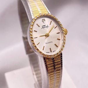 Dainty and Beautiful 1980s Vintage Ladies  Faberge Quartz Wristwatch Two Tone Gold and Silver Plated  Dial with Diamond New Battery