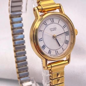 Vintage jaren 80 dames CITIZEN quartz-horloge (van Seiko) ronde geelgouden kast witte wijzerplaat met gouden uitbreidbare horlogeband