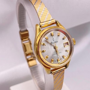 Vintage 1970s Ladies AROMA Yellow Gold Plated Round Case Date Window 17 Jewel Manual Wind Everyday Wristwatch with Gold Bracelet Strap