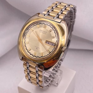 Vintage 1970s SEIKO Gold Plated &quot;UFO&quot; Case 19 Jewels Automatic Ref 7006-7030 Gold Dial Day Date Window Stainless Steel Original Seiko Strap