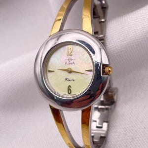 Vintage 1990s Ladies Gold and Silver Tone Round Case with Bangle Style Bracelet Quartz Wristwatch by ADINA