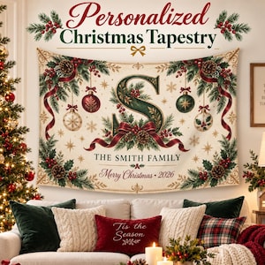 May include: A rectangular Christmas tapestry featuring a large green letter S, red ribbons, pine branches, pinecones, and ornaments. The text reads THE SMITH FAMILY and Merry Christmas 2026. The design is set against a cream background with gold accents.