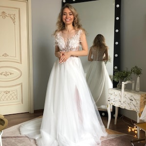 Trouwjurk veren, witte trouwjurk, trouwjurk met open rug, A-lijn trouwjurk, trouwjurk tule