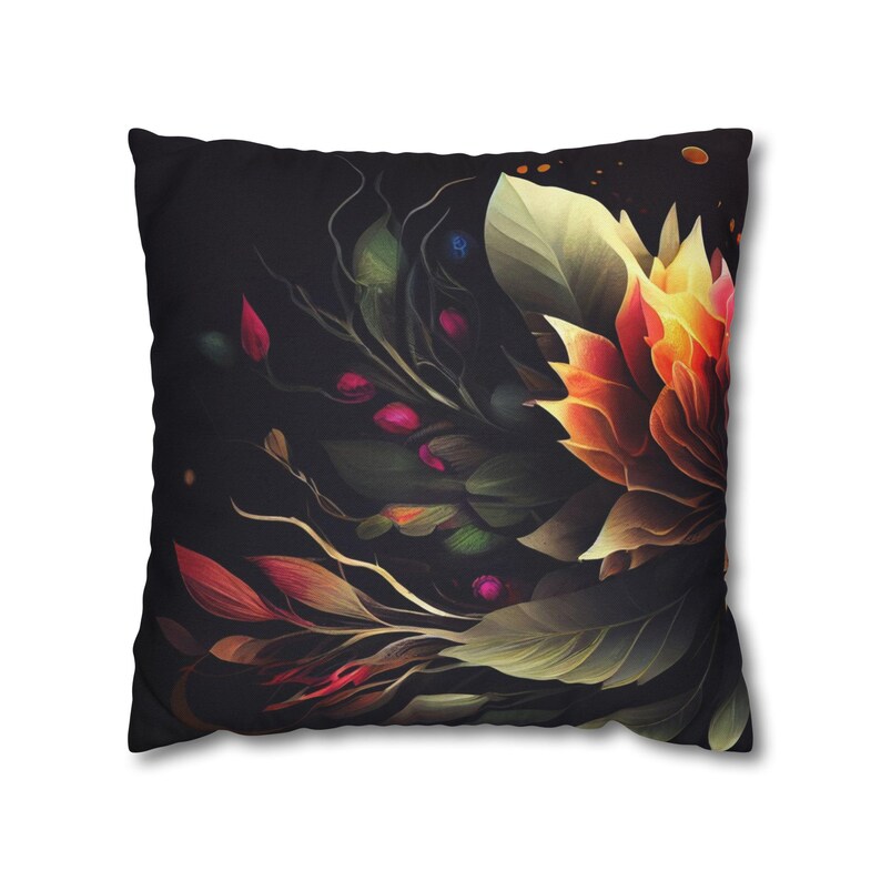 May include: A black throw pillow with a colorful floral design. The pillow features a large orange flower with green leaves and stems. The background is black with a subtle speckled pattern.