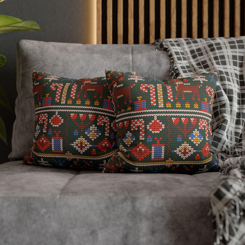 May include: Two decorative throw pillows with a green background and a colorful geometric pattern. The pillows are made of a soft, textured fabric and feature a festive design.
