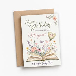 May include: A birthday greeting card with a brown envelope featuring an open book with colorful wildflowers and butterflies emerging from the pages. The text reads Happy Birthday for a wonderful friend, Margaret, 65, and Chapter Sixty-Five.