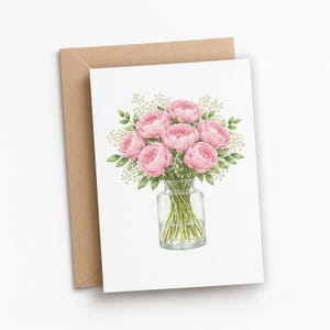 May include: A white greeting card with a watercolour illustration of pink peonies in a glass vase. The card is accompanied by a brown envelope. The flowers have green leaves and small white flowers.