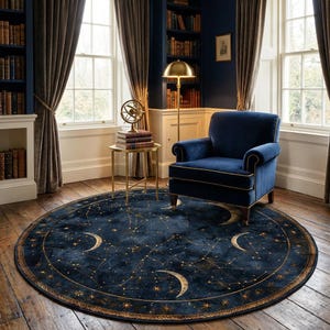 May include: A circular rug in navy blue, adorned with a celestial pattern of gold stars, constellations, and crescent moons. The rug is in a room with a blue armchair, a gold side table, and a floor lamp. The room has large windows and bookshelves.