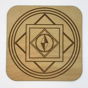 May include: A square wooden coaster with rounded corners. The coaster features a geometric design etched into the wood. The design includes concentric circles, squares, and diamond shapes, with a central diamond shape divided into two halves.