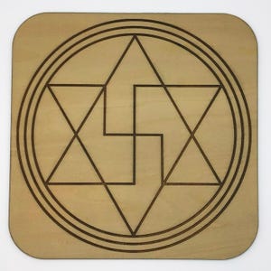 May include: A wooden square with a geometric design of overlapping triangles and circles, all etched in brown lines.
