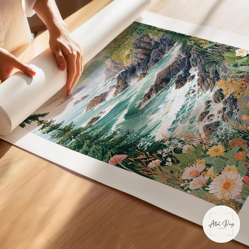 May include: A person unrolling a large art print featuring a watercolor landscape of a waterfall cascading down rocky cliffs. The print showcases vibrant greens, blues, and floral accents, with a white border. The print is on a wooden surface.