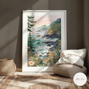 May include: A framed watercolor print of a coastal landscape. The artwork depicts a rocky shoreline with crashing waves, lush green hills, and colorful wildflowers. The sky transitions from pink to blue, creating a serene atmosphere. The print is displayed in a white frame.