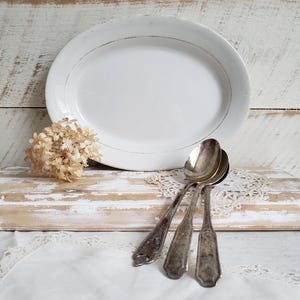 distressed ironstone platter , antique white oval serving platter with worn gold trim , farmhouse decor