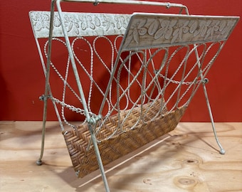 MCM, vintage folding, magazine rack features a white metal frame with ornate floral details and a woven wicker base