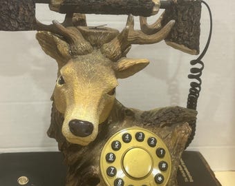 Sculpted deer buck bust phone, made of painted resin with a log-shaped receiver and coiled cord. Decor only