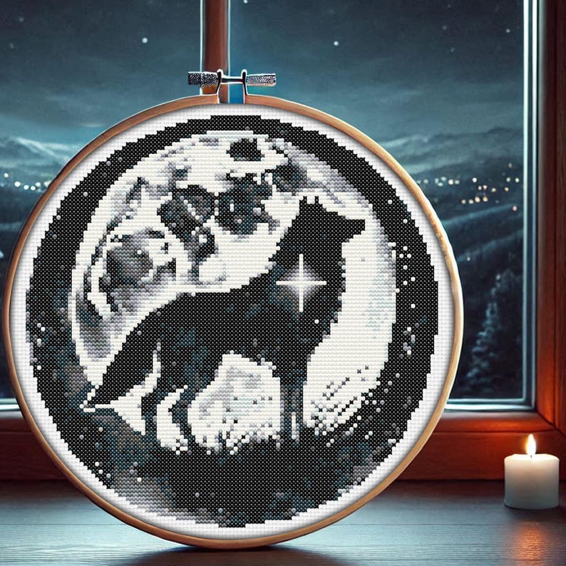 May include: A black and white cross-stitch embroidery of a wolf howling at the moon. The wolf is silhouetted against a full moon with a single star shining brightly. The background is a dark blue night sky with white stars.
