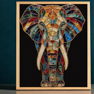 May include: A framed wall art piece featuring a stylised elephant head rendered in a stained glass mosaic pattern. The elephant is composed of vibrant, multi-coloured segments in shades of red, blue, yellow, and green, set against a solid black background.