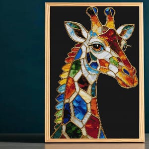 May include: A framed wall art piece featuring a giraffe head and neck rendered in a stained glass style. The giraffe is composed of multicolored geometric shapes in shades of blue, green, yellow, orange, and red, all outlined in dark lines.
